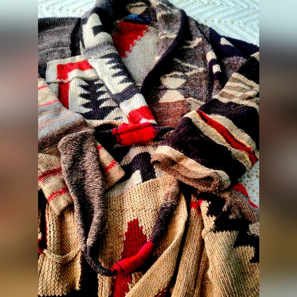 Shawl collar Aztec polo sweater with belt.